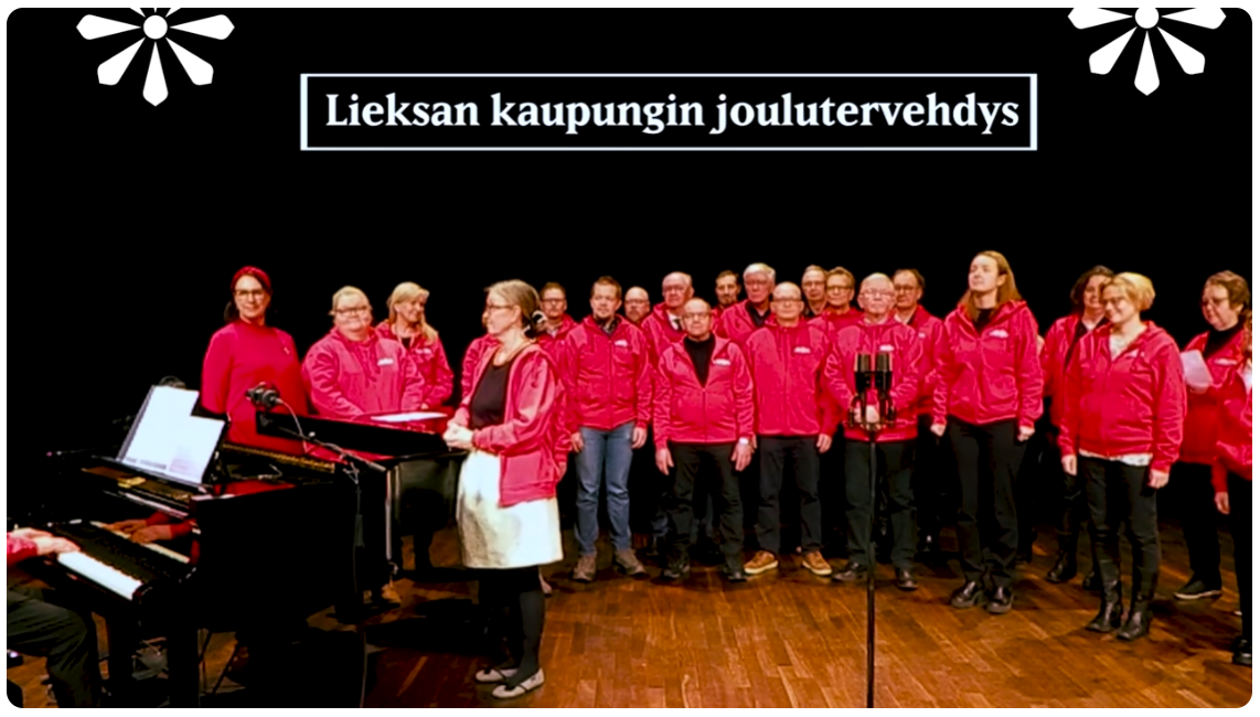 Joulutervehdystä laulavan kuoron kuva.